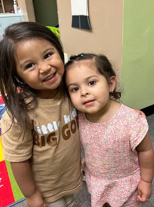 Two KidsWay students smiling together