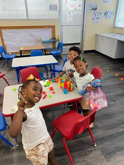 KidsWay students laughing together at a craft table