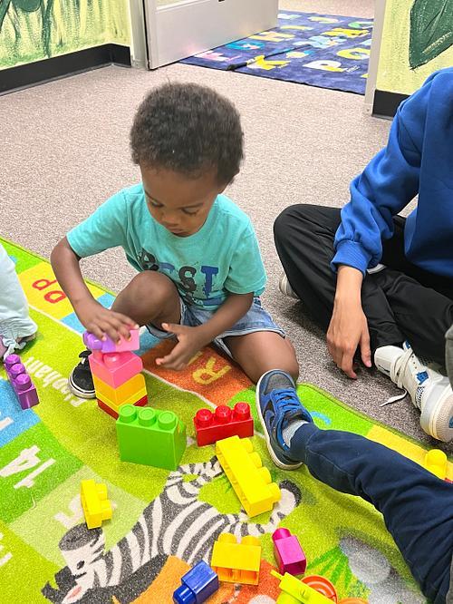 A student building with colorful blocks